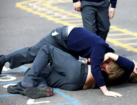 Getty Images Two schoolboys fighting