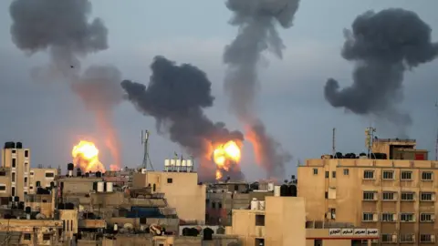 Reuters Flames and smoke rise from the Gaza Strip on 11 May 2021