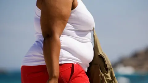 Getty Images Overweight woman's torso