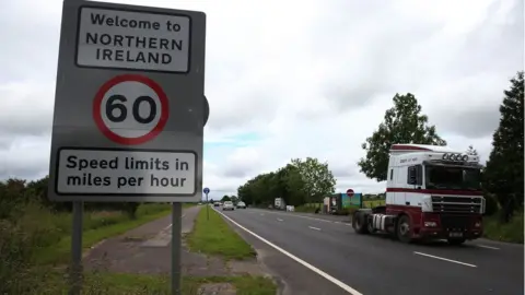 Brian Lawless Traffic crossing the border between the Republic of Ireland and Northern Ireland in the village of Bridgend, Co Donegal