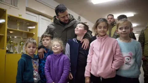 Ukrainian presidency handout Ukrainian President Volodymyr Zelenskyy visits one of the 'Points of Invincibility', special shelters established for all basic services across the country after power cuts due to the war, and gathers with children here, in Kyiv, Ukraine on November 25, 2022.