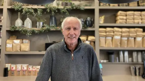 Andy Rollings behind the counter of his cafe in Preston Park