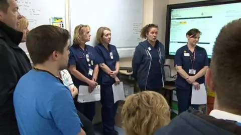 Staff discuss the day ahead at the Royal Gwent