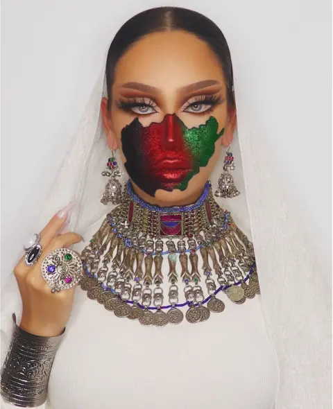 Nilab Adelyar An Afghan female model with make-up of the Afghanistan flag painted on her face