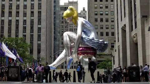 Getty Images A 45 ft high inflatable ballerina created by artist Jeff Koons in the Rockefeller Center, 23 May 2017