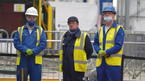 PA Media Babcock workers look on during Thursday's steel-cutting ceremony