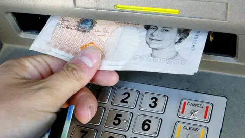 PA Man withdrawing money from cash machine