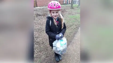 Lianne Marie Simpson Lean Simpson with a bag of rubbish