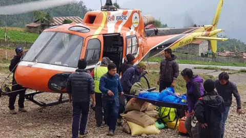 ANG TASHI SHERPA Body of Japanese climber brought down by helicopter from higher camp of Everest