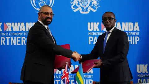 Reuters Home Secretary James Cleverly and Rwandan Minister of Foreign Affairs Vincent Biruta sign a new treaty in Kigali, Rwanda