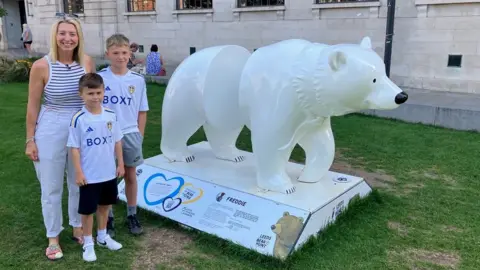 Phil Bodmer/BBC Emma McDonald with sons Freddie and Louie