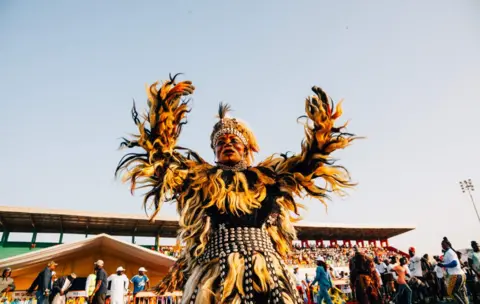 AFP A masked man performs a dance as supporters of Senegal"s presidential candidate Madicke Niang attend a rally in The Alassane Djigo Stadium in Pikine on February 22, 2019