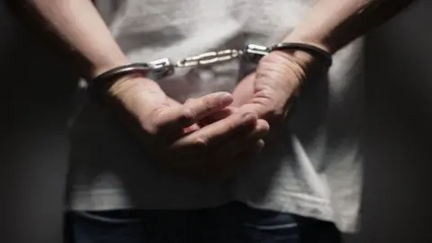 Getty Images Man in handcuffs