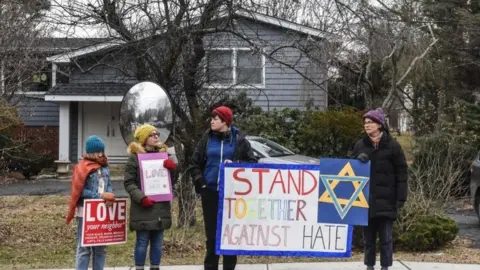 Getty Images People show support to the Jewish community with banners