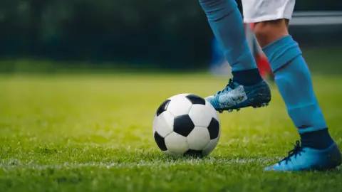 Getty Images Footballer with foot on ball
