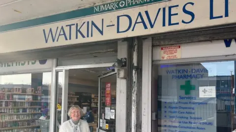 Betty Pritchard outside Watkin-Davies pharmacy