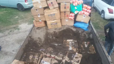 Uganda Revenue Authority Boxes covered in sand