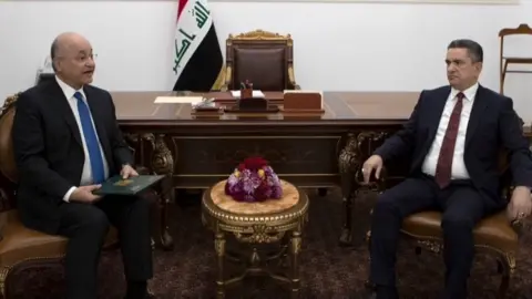 Reuters Iraqi President Barham Saleh (left) tasked Adnan al-Zurfi (right) with forming a new government