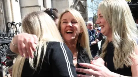 PA Media Former post office worker Janet Skinner (centre) outside the Royal Courts of Justice, London, after having her conviction overturned by the Court of Appeal