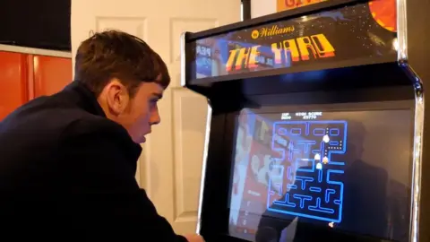 Winnie Ngai/BBC Issac playing a video game