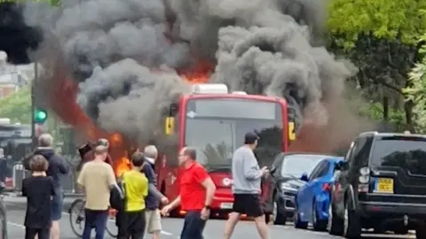 A diesel single-decker bus on fire