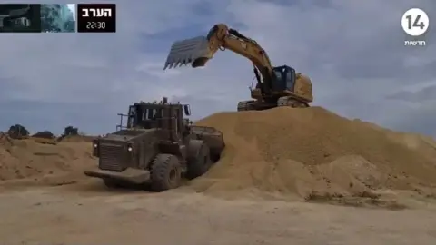 עכשיו 14 A digger and a truck in Gaza
