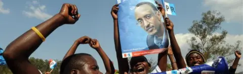 AFP Supporters of the ruling Rwandan Patriotic Front (RPF) carry a poster as they attend a campaign rally on August 4, 2010 in Kigali ahead of next week's presidential election.