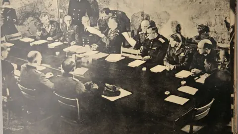 Ray Chick Representatives of Great Britain, the US, Russia and France face German delegates at Rheims