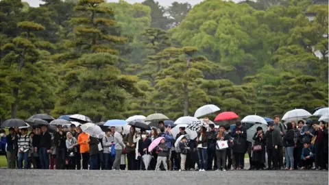 Reuters People outside the Imperial Palace in Tokyo