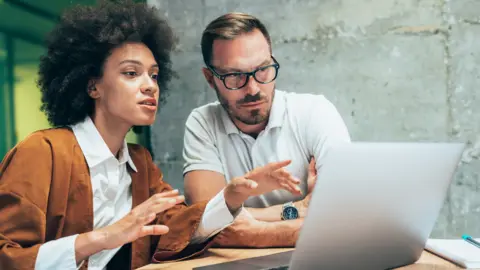 Getty Images Woman and man working at computer