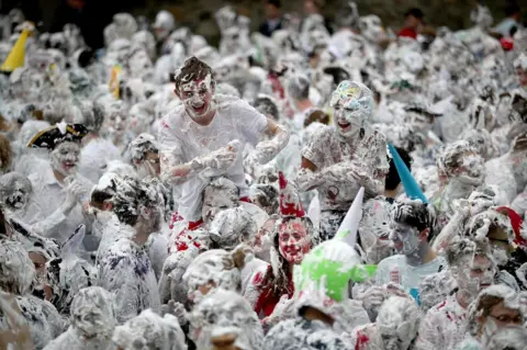 Jane Barlow/ PA Students covered in shaving foam.