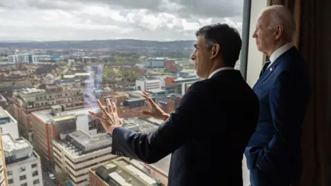 Simon Walker Rishi Sunak and Joe Biden look at the view over Belfast from the 23rd floor of the Grand Central Hotel