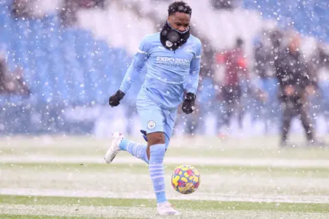 Naomi Baker/Getty Images Raheem Sterling of Manchester City warms up in the snow prior to the Premier League match between Manchester City and West Ham United at Etihad Stadium