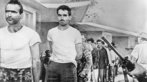 Getty Images Watched by armed guards, grim-faced invaders are marched off to prison from temporary quarters at Giron Beach, Las Villas province, after their capture by Castro forces
