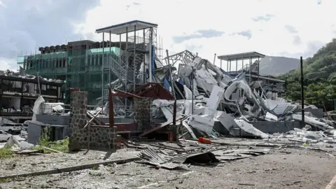 Damaged infrastructure is seen following an explosion at the Providence industrial area in Mahe on December 7, 2023