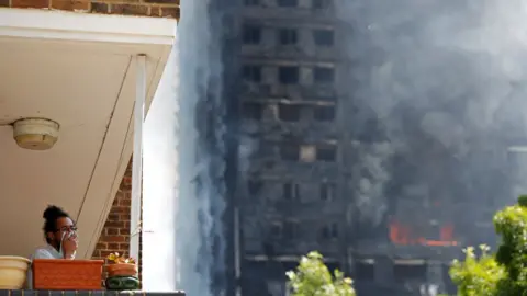 AFP/Getty man in flat looking at fire