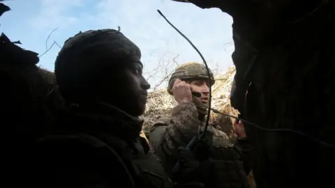 EPA Ukrainian servicemen check the situation at the positions on a front line near the Svetlodarsk