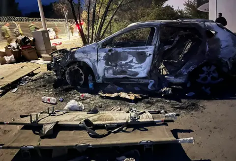 BBC/Oren Rosenfeld A burnt out car in kibbutz Be'eri