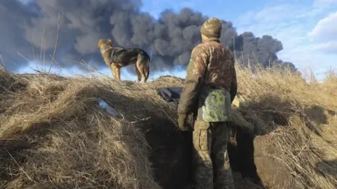 EPA A Ukrainian serviceman stands in a position following a Russian missile attacked near Kyiv