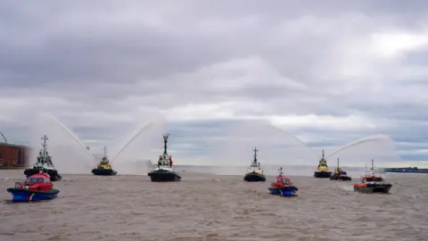 PA Media River tugs perform Fleur De Lis, (spraying of water from their fire cannons) as vessels gather on the River Mersey in Liverpool