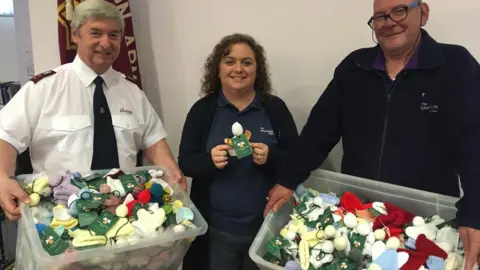 The Salvation Army (L-R) Major Ian Davies, leader of the Salvation Army Wrexham, Karen Edwards and Peter Jones with knitted angels