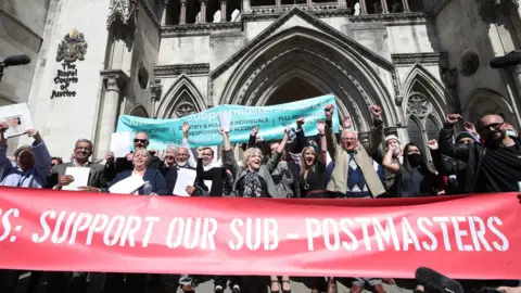 PA Media Postmasters celebrating their convictions being overturned outside the Royal Courts of Justive in 2021