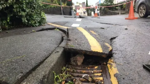 Flooding in New Quay, Ceredigion, caused damage to the road