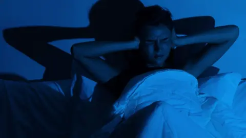 Getty Images Woman with insomnia because of loud noises