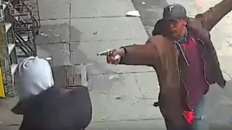 NYPD Vassell points a gun
