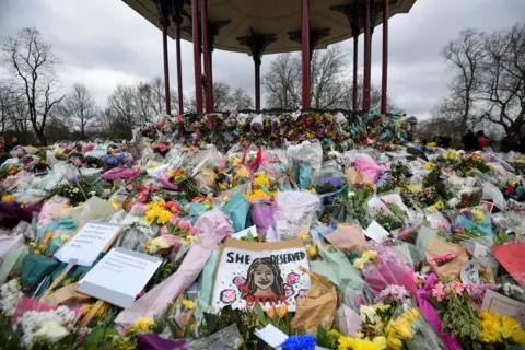 Reuters Floral tributes and messages at a memorial site at Clapham Common Bandstand, following the kidnap and murder of Sarah Everard, in London, Britain March 16, 2021