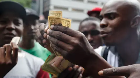 AFP Public transport drivers complain about having to pay for fuel in US dollars at a fuel station