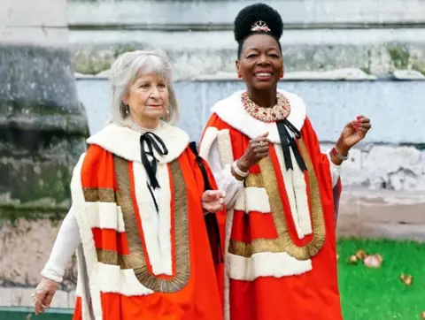 PA Media Dame Floella Benjamin in red, gold and white robes at Westminster Abbey