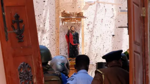 EPA A statue of St. James is pictured after a bomb blast inside a church in Negombo