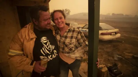 Getty Images Lawrence and Claire Cowie are pictured after defending their home from a fast moving fire on Bumbalong Road, Bredbo North